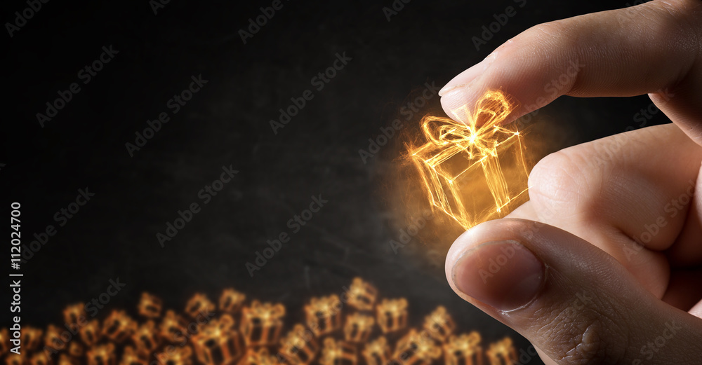 Fototapeta premium Glowing symbol between fingers