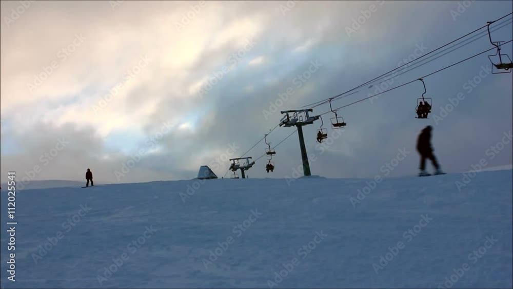 Cable car, skiers, snowboarders on the mountain among the trees Cable car, skiers, snowboarders on the mountain among the trees