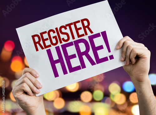 Register Here placard with bokeh background photo