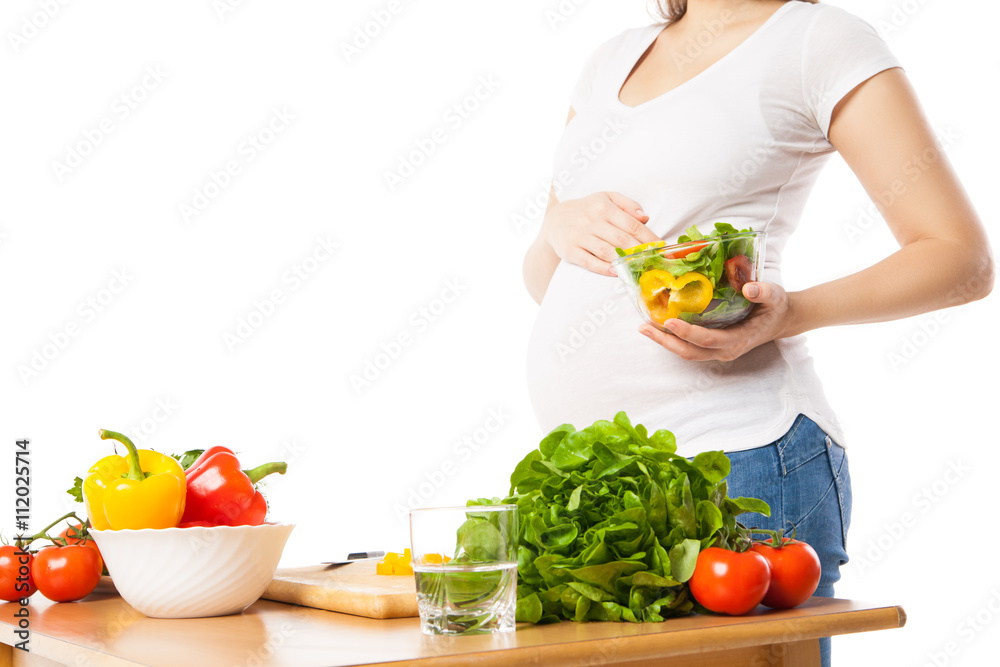 Close-up of pregnant woman holding bowl with fresh vegetables Close-up of pregnant woman holding bowl with fresh vegetables