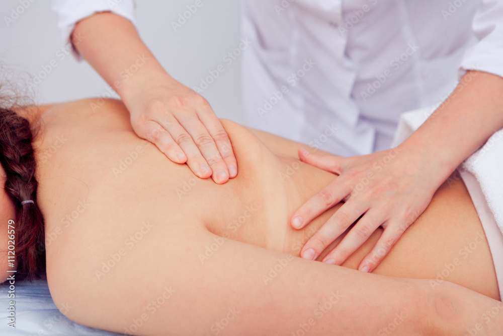 professional masseur doing massage of female back in the beauty salon professional masseur doing massage of female back in the beauty salon