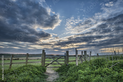 Beautiful English countryside landscape over fields at sunset