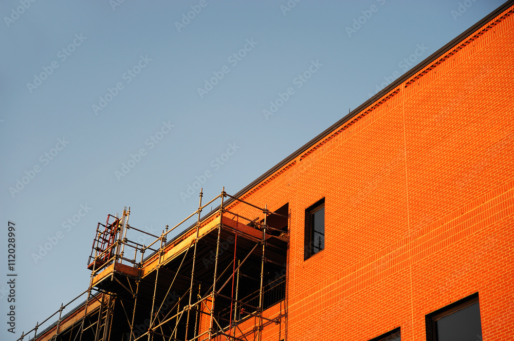 dusk sunlight on the brick wall building under construction