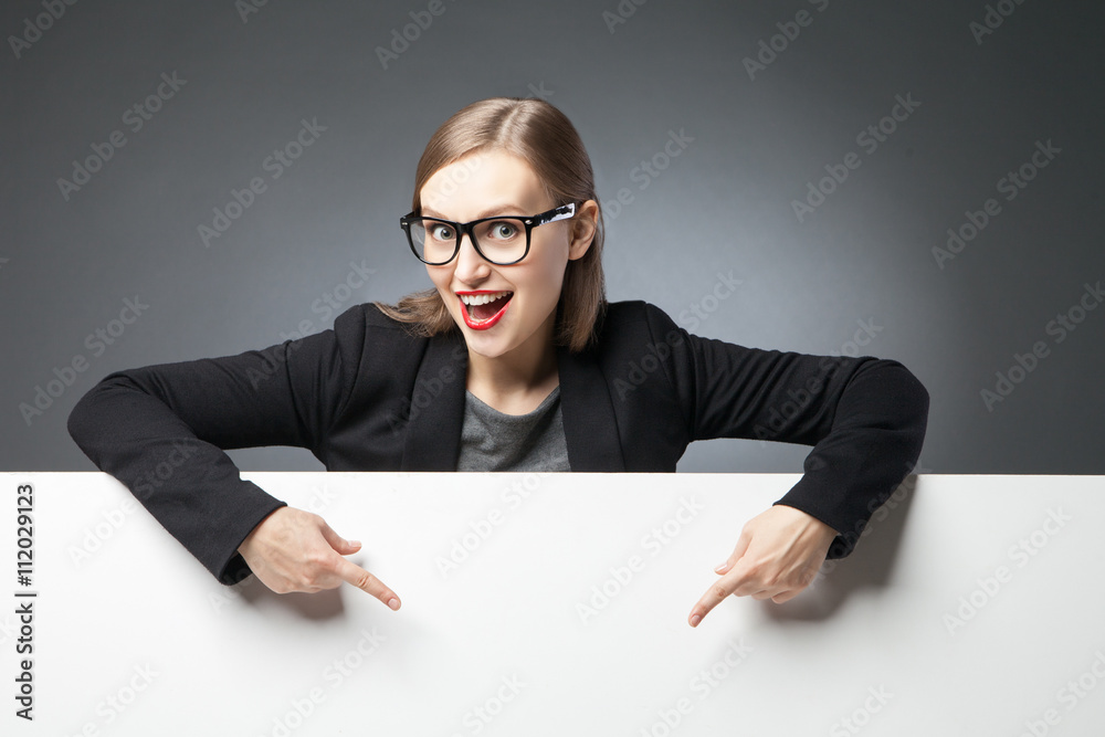 Happy woman with open mouth pointing at blank space Happy woman with open mouth pointing at blank space