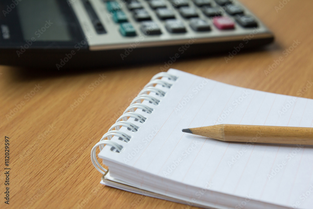 Calculator, notebook and pencil Calculator, notebook and pencil