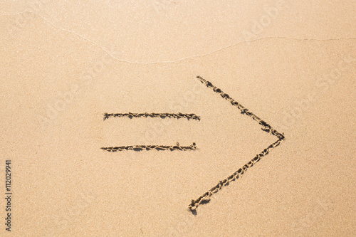 Drawn arrow on the sand
