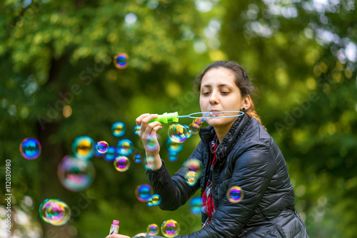 Young Woman Blowing Bubbles