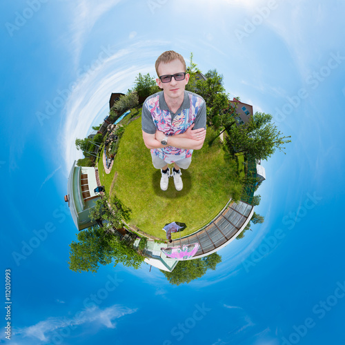 man standing on the grass in the garden, and the whole world is a ball