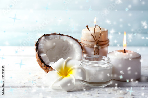 Spa coconut products on light wooden background with snow effect