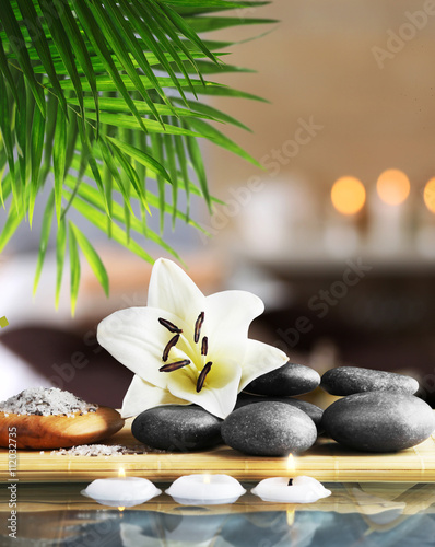 Fototapeta Naklejka Na Ścianę i Meble -  Composition with spa stones and flower on blurred background