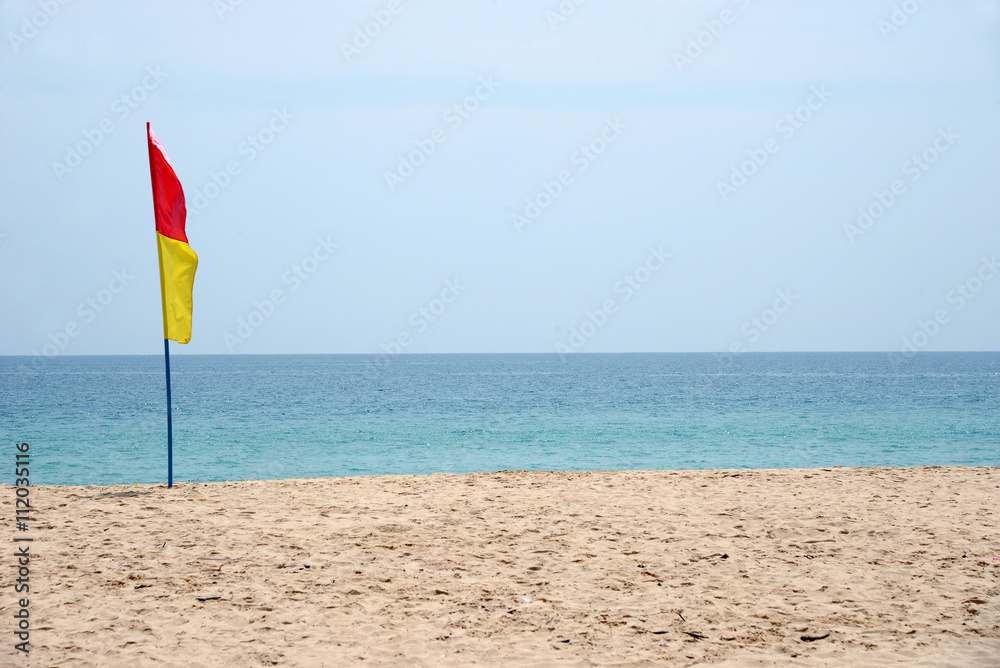 Swimming safety flags on the beach with blue sky Swimming safety flags on the beach with blue sky