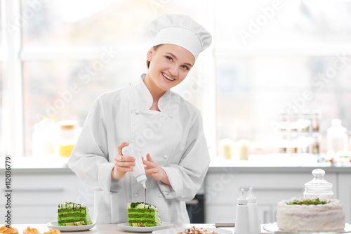 Female chef working at kitchen
