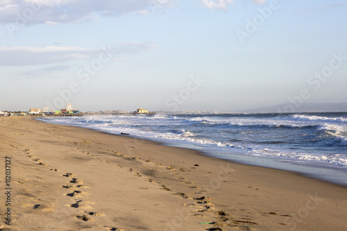 Amusement Park on the Pacific ocean  the beach landscape. The ocean  beach and blue sky in USA  Santa Monica. The ocean and waves during strong winds.