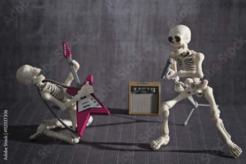 Two skeletons playing rock music