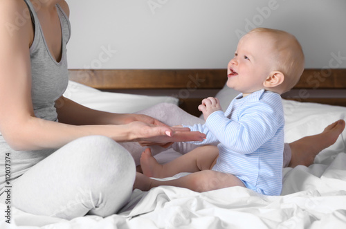 Adorable baby sitting with ...