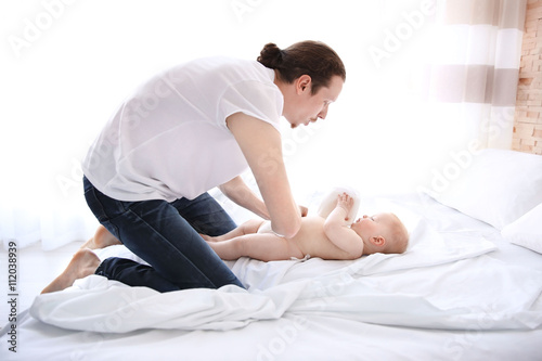 Father changing diaper to h...