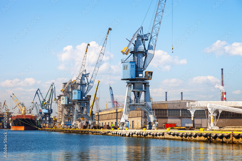 View of seaport wharf with cranes in Gdansk, Poland.