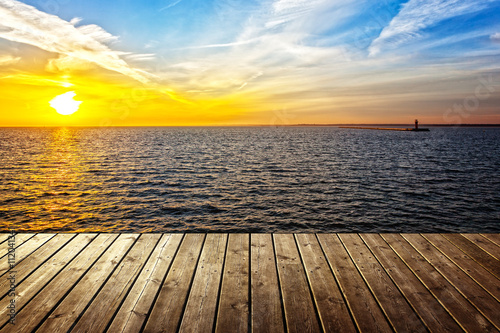 Sunset background with empty plank and sea. © Nightman1965
