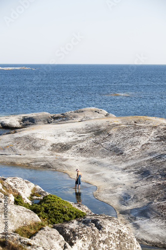 Woman walking in sea photo