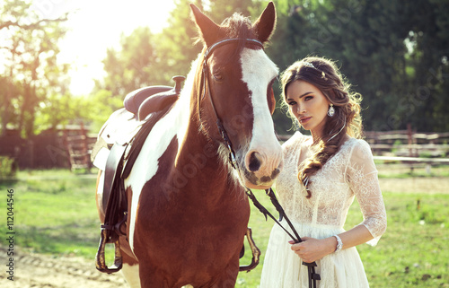 Beautiful glamour woman with a horse