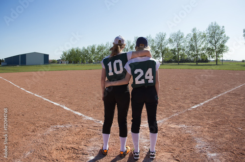 Photography Two teenage girls with their backs turned and arms around each other standing at
