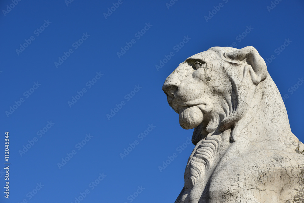Majestic Lion (with copy space). Marble statue of a lion from Vittoriano monument, a huge building in the center of Rome designed by architect Giuseppe Sacconi in 1883