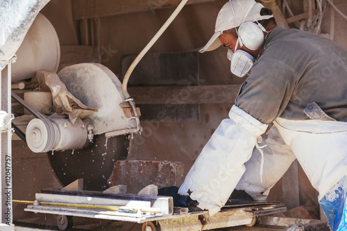 Bosnia and Herzegovina, Bileca, Stone cuter working on cutting machine photo