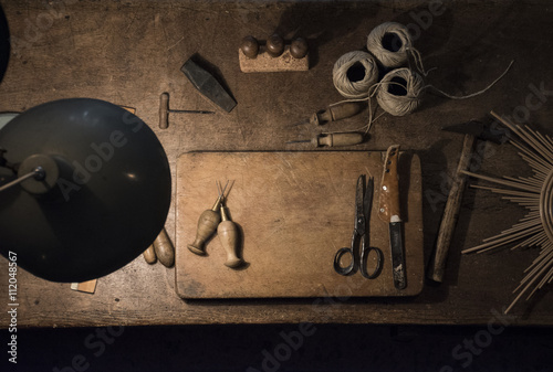 Tools and twine rolls on a wood table in a workshop photo