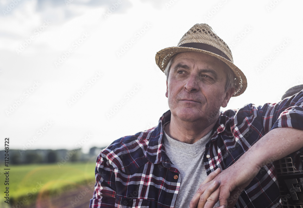 Portrait of a farmer wearing straw hat Portrait of a farmer wearing straw hat