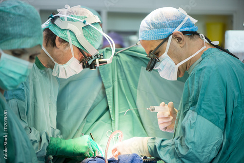 Heart surgeons during a heart operation photo