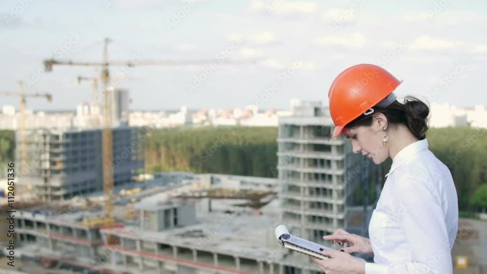 Woman architect inspects the construction site Woman architect inspects the construction site