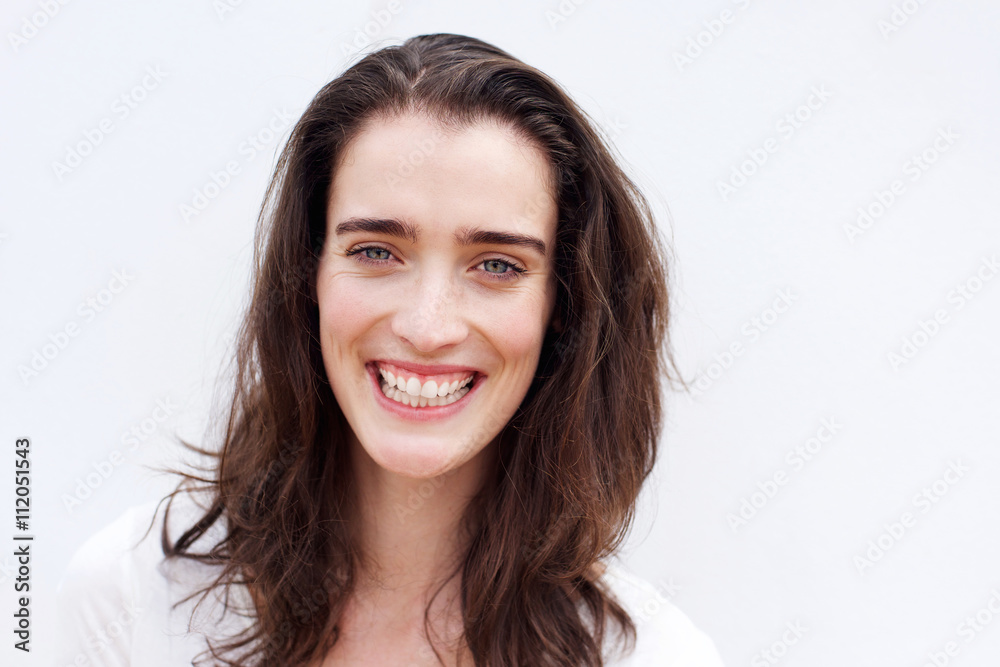 Cheerful young woman smiling against white background Cheerful young woman smiling against white background