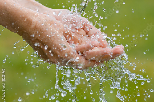 washing hands on nature background, closeup