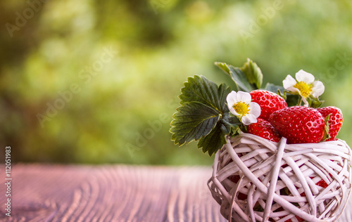 strawberries on a wooden old table outdoors