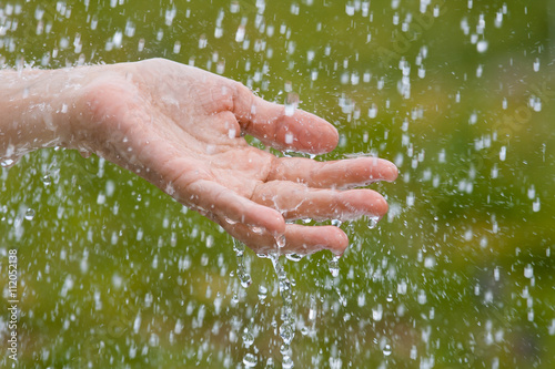 hand of woman under rain