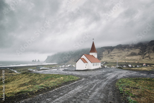Iceland, Vik, view to village and church, dramatic sky photo