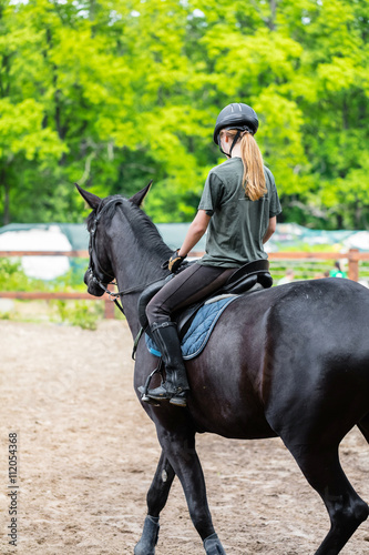 girl sportsman rides on horse