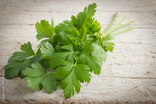 Bunch of fresh parsley on wooden rustic background