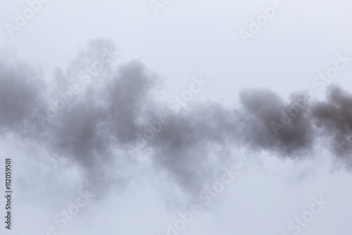 Smoke from a pipe on a cloudy sky © schankz