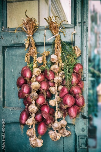 Red onion and garlic draped on old door photo