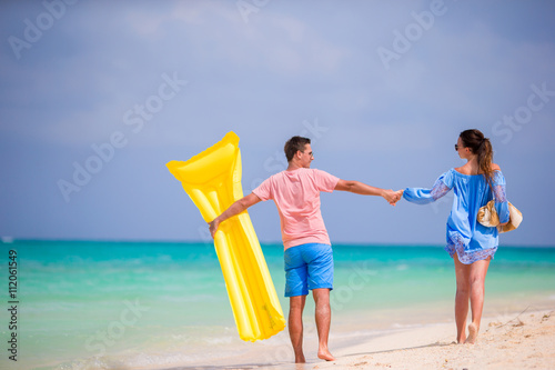 Young family on white beach at tropical vacation