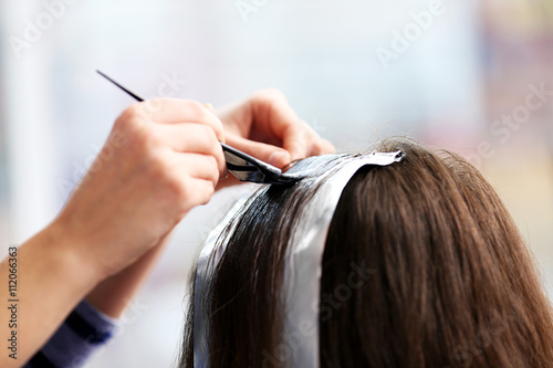 Professional hairdresser coloring hair