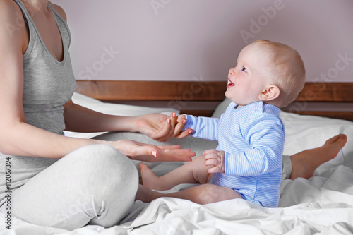 Adorable baby sitting with ...