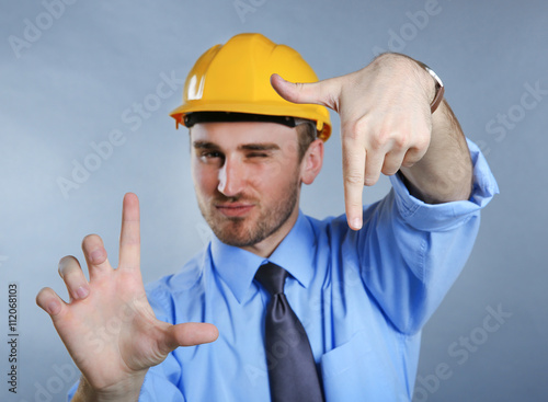 Man in helmet making sign w...