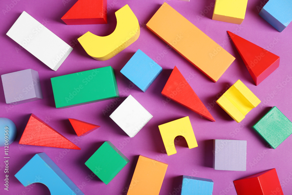 Colorful wooden kids toys on purple background Colorful wooden kids toys on purple background