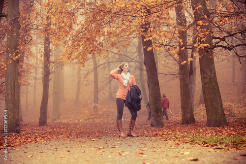 Fashion blonde woman with jacket in autumn park.