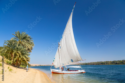Felucca, traditional wooden sailboat on shore of Nile, Egypt.