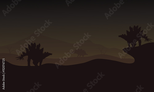 At night Stegosaurus in hills scnery