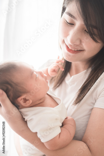 Happy mother holding adorable child baby boy