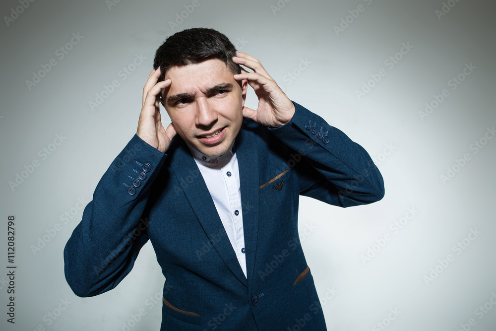 Attractivebusinessman holding a jacket with both hands on head Attractivebusinessman holding a jacket with both hands on head
